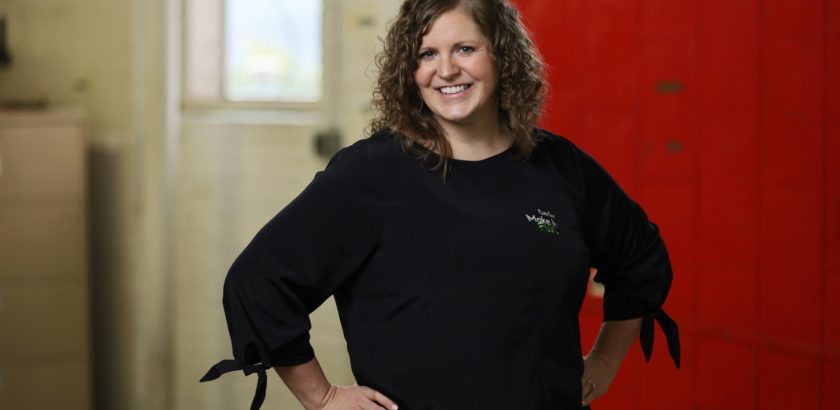 Headshot of FloraCraft Marketing Director Jamie Sutton standing in front of a red door.